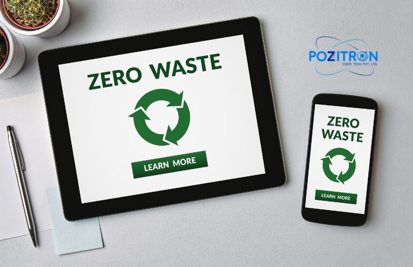 Tablet and smartphone displaying 'Zero Waste' with a green recycling symbol and 'Learn More' button, placed on a desk with Pozitron Chemtech Pvt. Ltd. logo, promoting sustainable digital awareness.